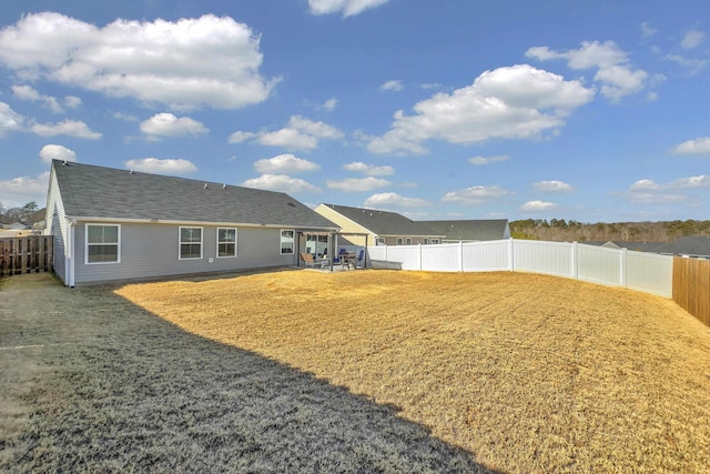 back of house featuring a lawn