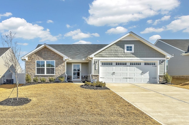 craftsman inspired home featuring a garage, central air condition unit, and a front lawn