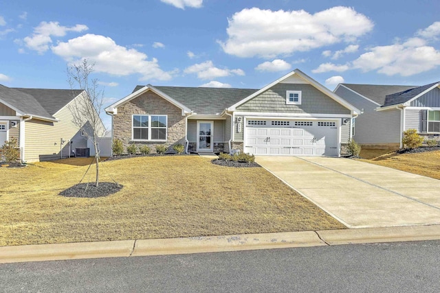 view of front of home featuring a garage, a front lawn, and central air condition unit