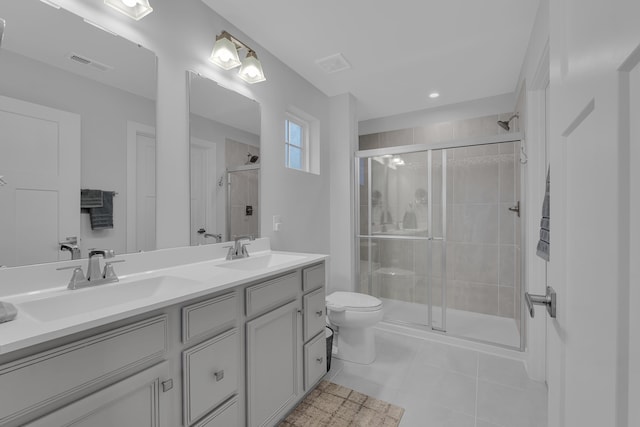 bathroom featuring vanity, tile patterned flooring, and a shower with shower door