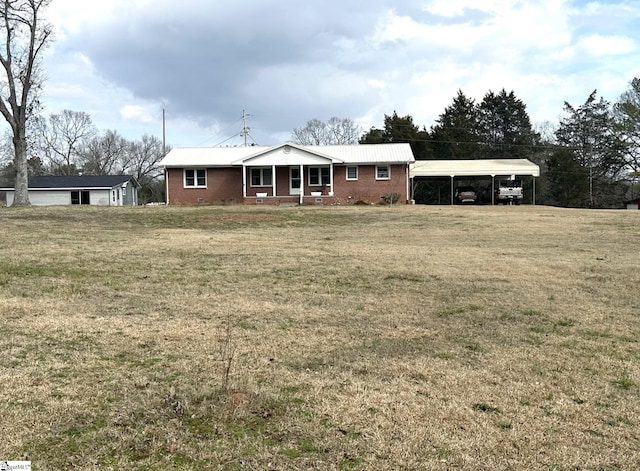 view of front facade with a porch, a carport, and a front lawn