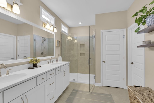 bathroom with tile patterned flooring, vanity, and a shower with shower door