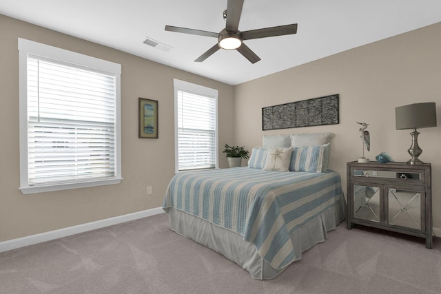 bedroom featuring light carpet and ceiling fan