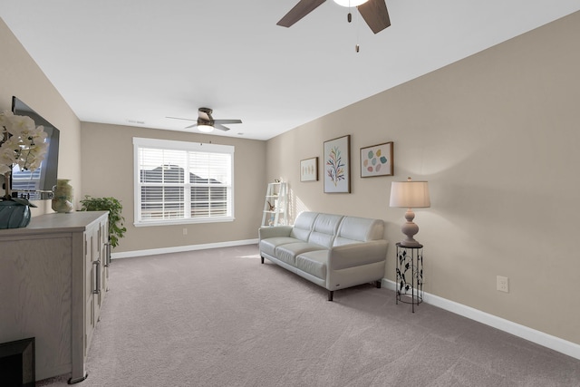 living room with ceiling fan and light colored carpet