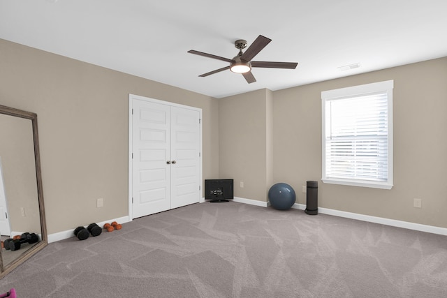 unfurnished bedroom featuring ceiling fan, a closet, and light carpet