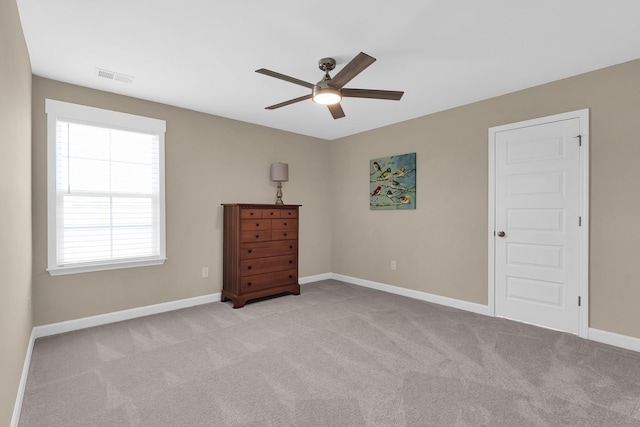 unfurnished bedroom with ceiling fan and light colored carpet