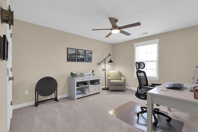 carpeted home office featuring ceiling fan