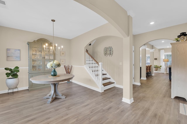 foyer entrance featuring an inviting chandelier and light hardwood / wood-style flooring