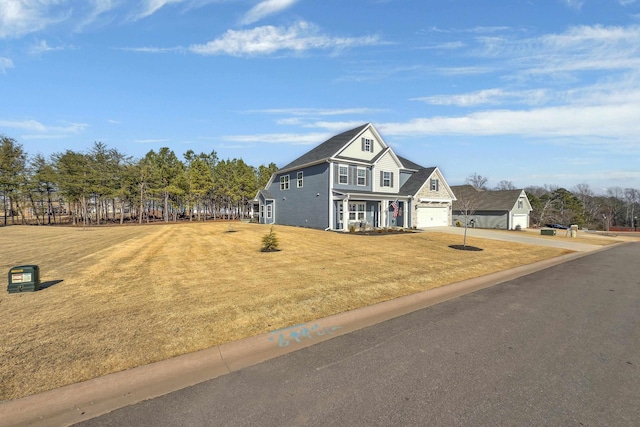 view of front of home featuring a garage and a front lawn