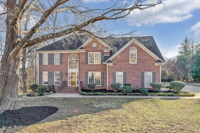 colonial home with a front lawn