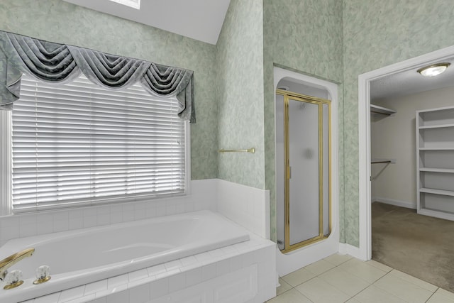 bathroom featuring plus walk in shower and tile patterned floors