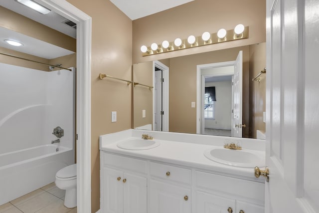 full bathroom with washtub / shower combination, tile patterned floors, toilet, and vanity