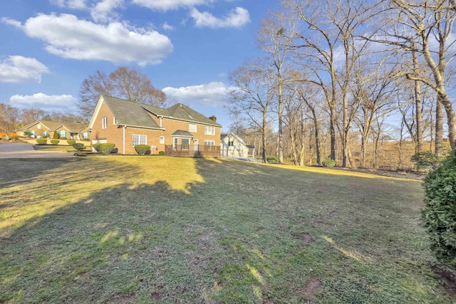 view of side of home with a yard