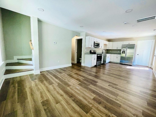 kitchen featuring sink, hardwood / wood-style flooring, white cabinets, and appliances with stainless steel finishes