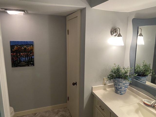 bathroom featuring vanity and toilet