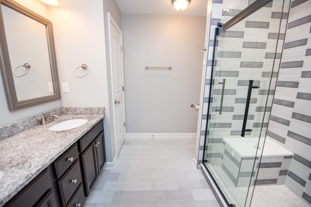 bathroom with vanity and a shower with door