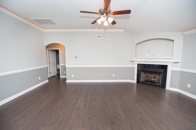 unfurnished living room featuring a tiled fireplace, ornamental molding, dark hardwood / wood-style floors, and ceiling fan