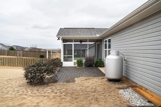 view of yard with ceiling fan, a patio, and a sunroom