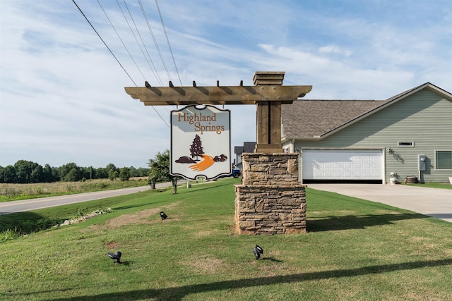 view of front facade with a garage and a front lawn