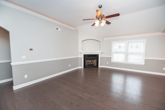 unfurnished living room featuring a tile fireplace, ornamental molding, ceiling fan, and dark hardwood / wood-style flooring