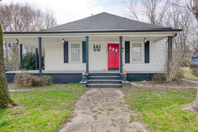 bungalow with covered porch and a front lawn