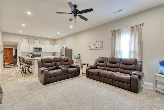 living room with light colored carpet and ceiling fan