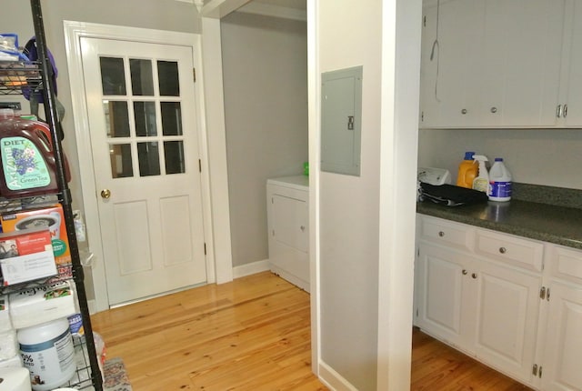 entryway featuring washer / dryer, electric panel, and light hardwood / wood-style flooring