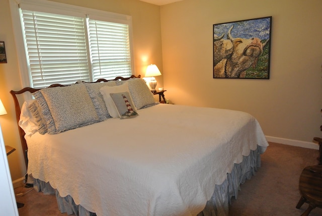 bedroom featuring dark carpet