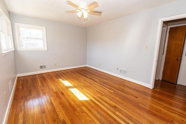 empty room featuring hardwood / wood-style floors and ceiling fan