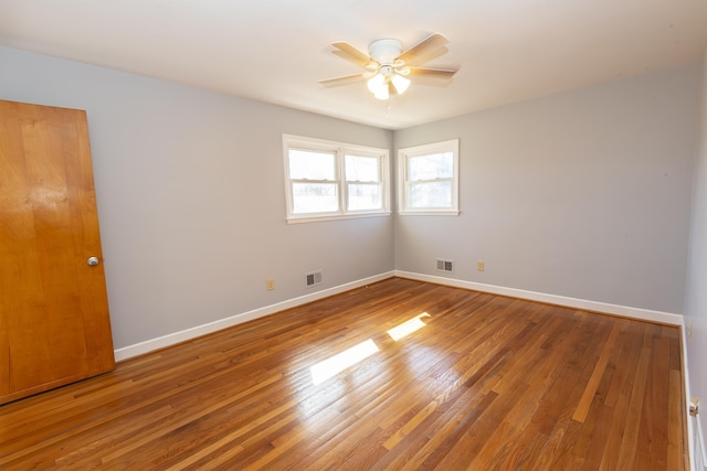 unfurnished room featuring hardwood / wood-style floors and ceiling fan