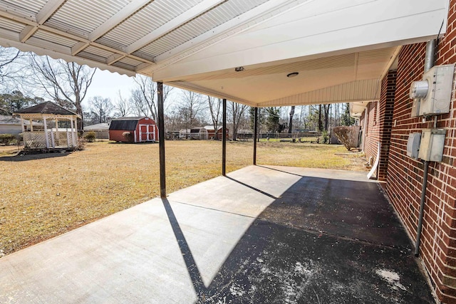 view of patio with a gazebo and a shed