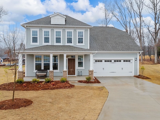 view of front facade with a porch, a garage, and a front lawn