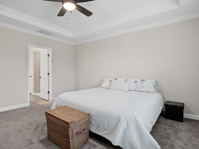 carpeted bedroom with a raised ceiling, crown molding, and ceiling fan