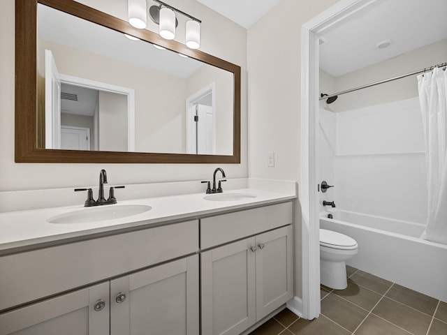 full bathroom featuring shower / bath combination with curtain, tile patterned floors, toilet, and vanity