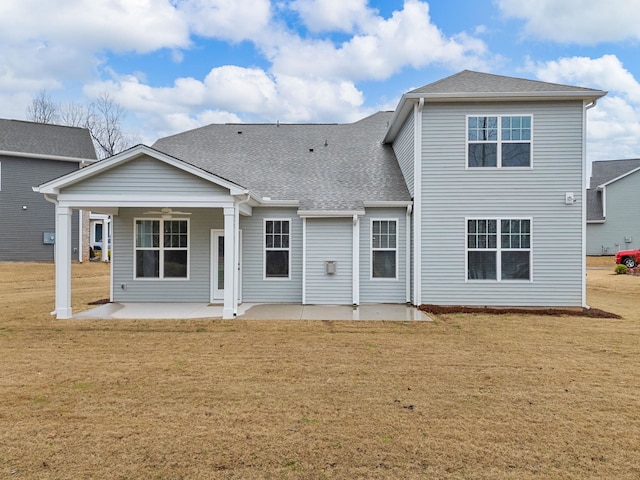 rear view of house with a patio area and a lawn