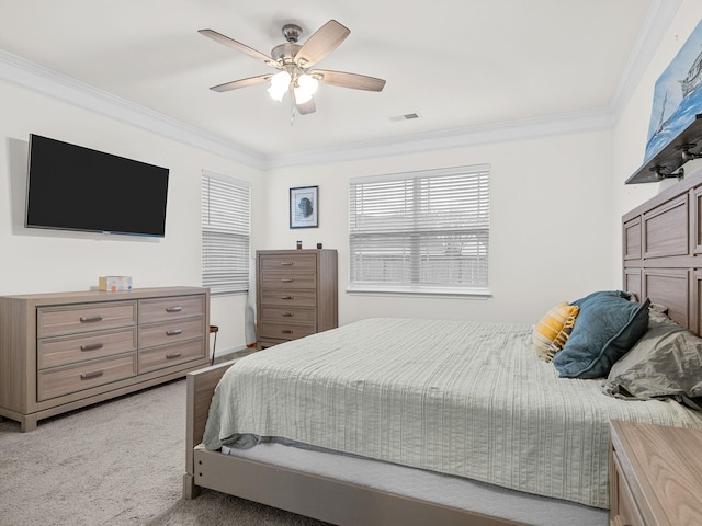 bedroom featuring ornamental molding, light colored carpet, and ceiling fan
