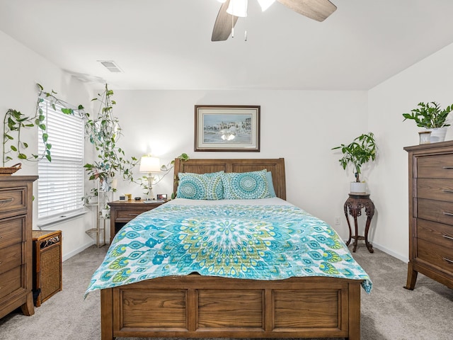 bedroom with ceiling fan and light carpet