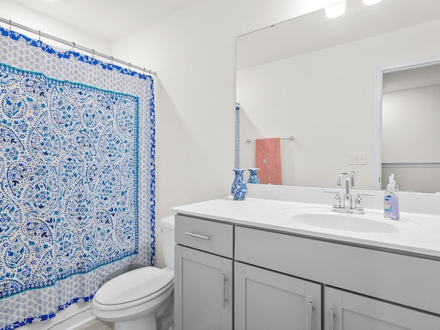 full bathroom featuring vanity, toilet, and shower / bath combo with shower curtain