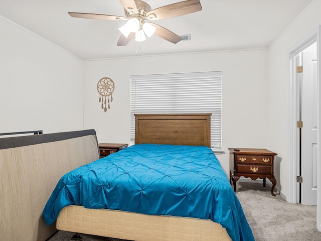 bedroom featuring ceiling fan, ornamental molding, and carpet floors