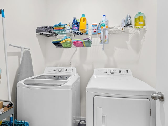 clothes washing area with washer and dryer