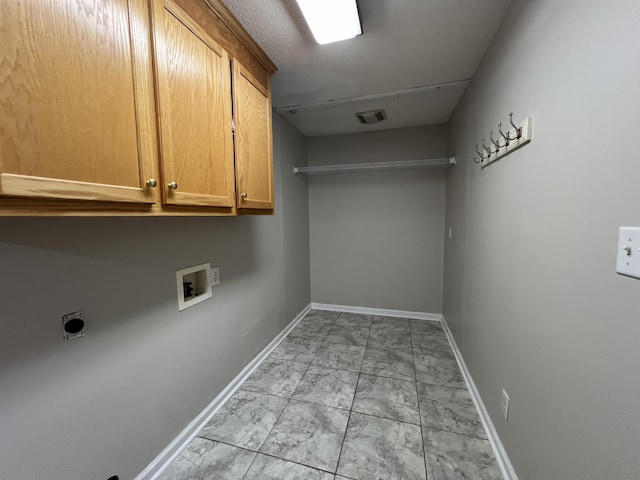 washroom with washer hookup, cabinets, and hookup for an electric dryer