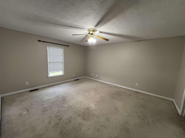 empty room with carpet, a textured ceiling, and ceiling fan