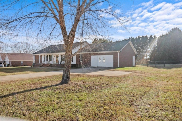 ranch-style house featuring brick siding, concrete driveway, a front yard, and fence