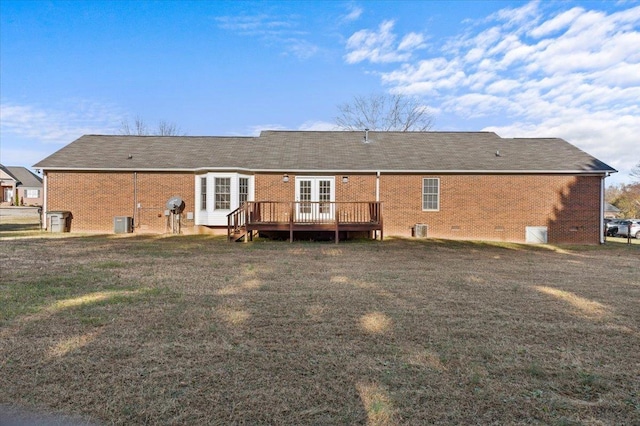 rear view of property featuring a wooden deck, french doors, cooling unit, and a lawn