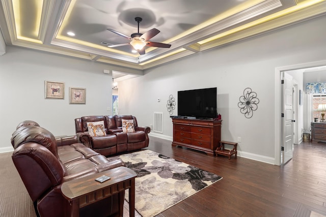 living room with dark hardwood / wood-style floors, ornamental molding, a raised ceiling, and ceiling fan