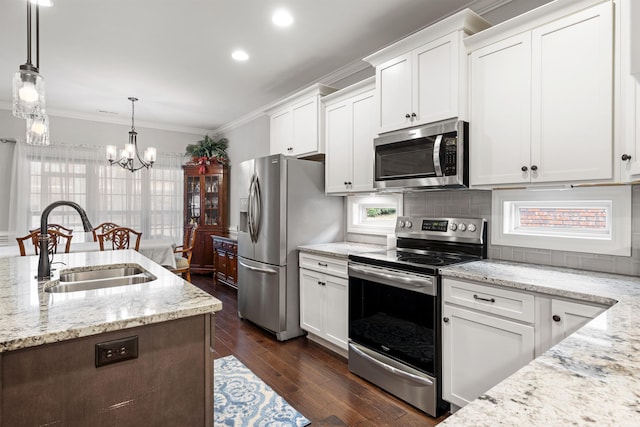 kitchen with stainless steel appliances, decorative light fixtures, sink, and white cabinets