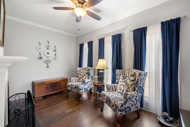 living area with crown molding, dark hardwood / wood-style floors, a wealth of natural light, and ceiling fan