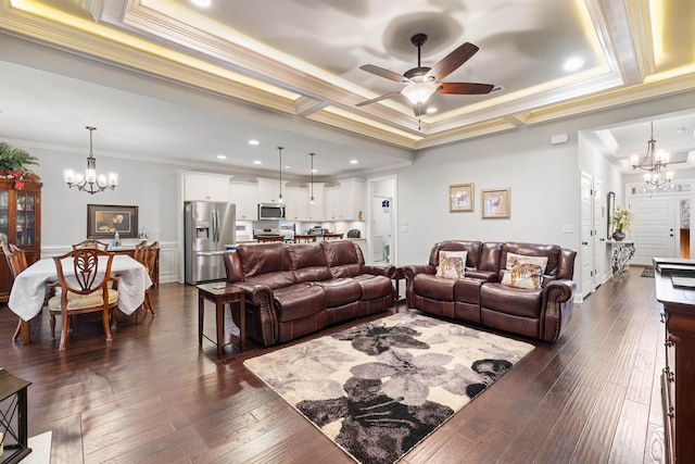 living room with crown molding, dark hardwood / wood-style floors, a raised ceiling, and ceiling fan with notable chandelier