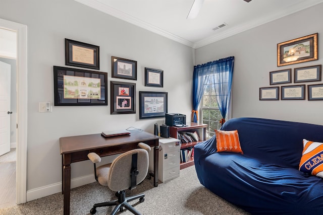 carpeted office featuring ornamental molding and ceiling fan