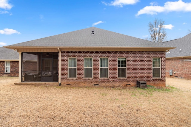 back of property with a sunroom